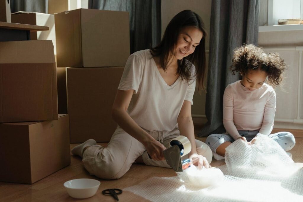 Mom packing for the move with a kid