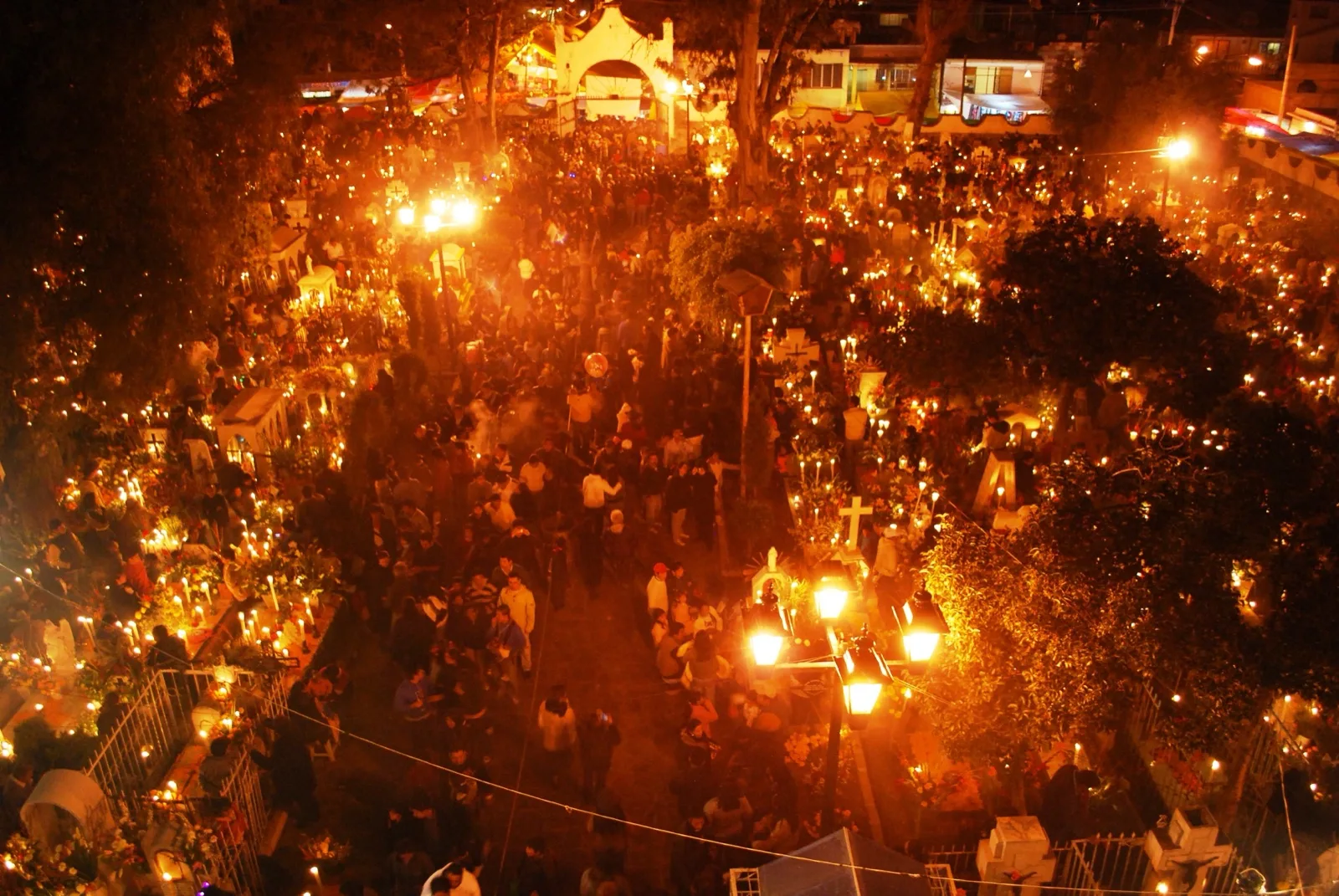 The cemetery at San Andrés Mixquic at night, glowing with thousands of candles among crowds of visitors.